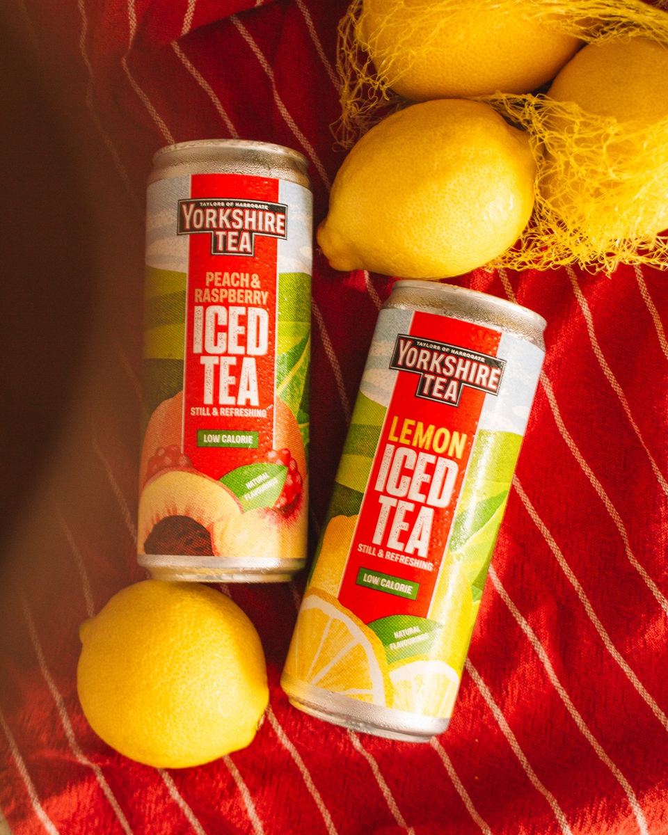 Yorkshire Tea iced tea cans on a red striped blanket with lemons